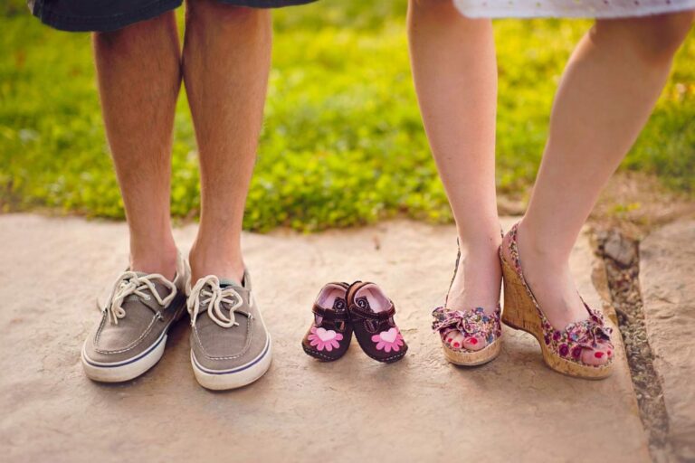 couple and baby shoes