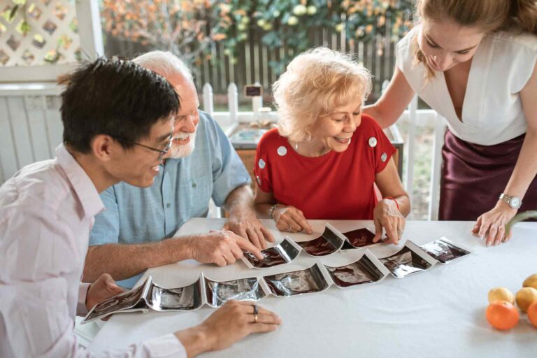 happy family looking at pregnancy scans