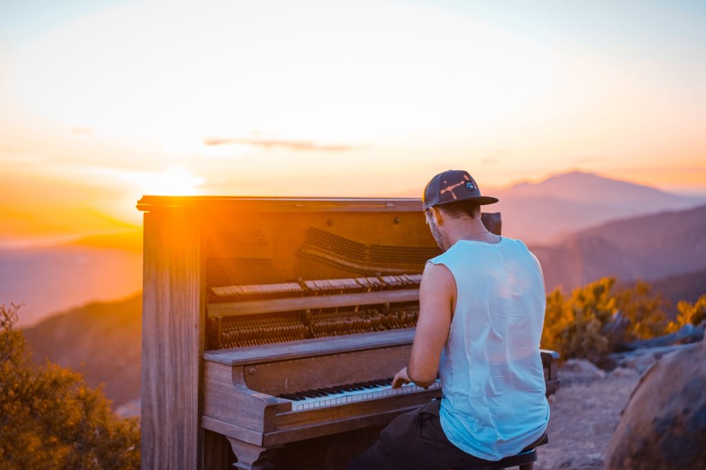 man playing piano outdoor