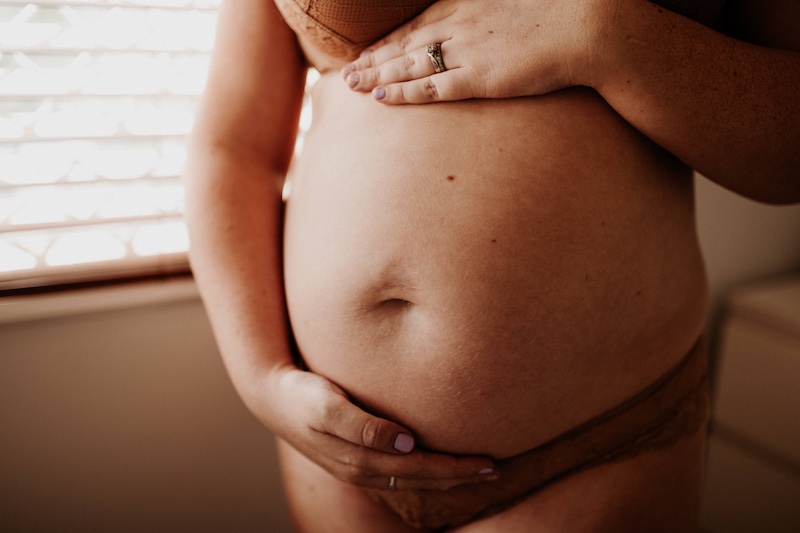pregnant woman holding her belly