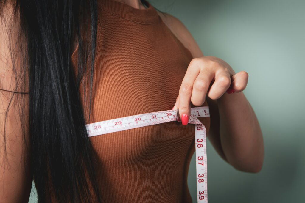 woman measuring her bust